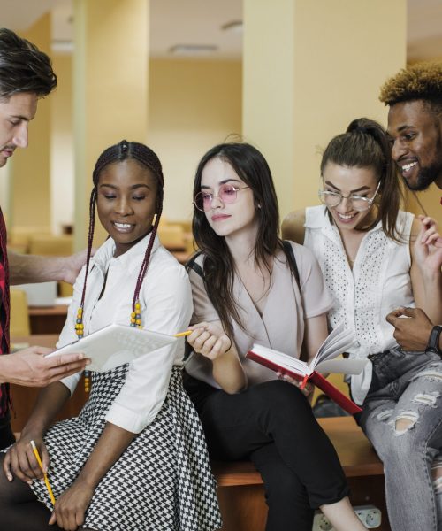 students-posing-with-notepads