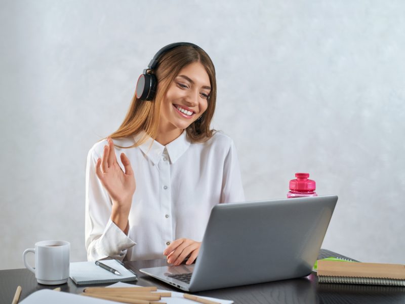woman-waving-and-talking-during-online-education-on-laptop.jpg